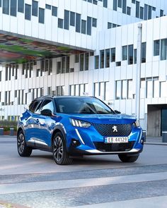 a blue car parked in front of a building