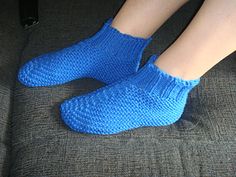 a person wearing blue socks sitting on a couch