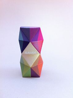 a colorful vase with the word gaudi written on it's front and side