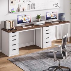 a desk with two computer monitors on top of it and a chair next to it