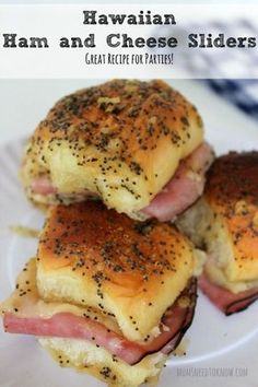 ham and cheese sliders on a white plate with black sesame seed sprinkles