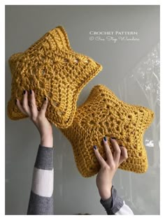 two crocheted pillows being held up by hands