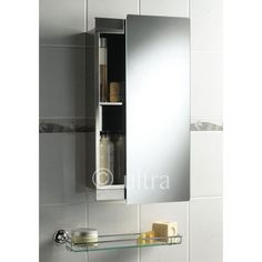 a bathroom mirror with shelves above it and soaps on the shelf below them in front of a white tiled wall