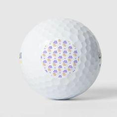 a white golf ball with purple and yellow designs on it