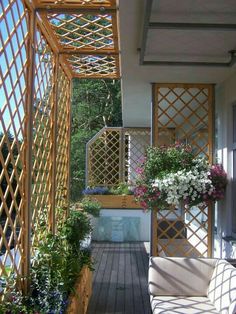 an outdoor patio with wooden trelliss and potted plants on the deck area