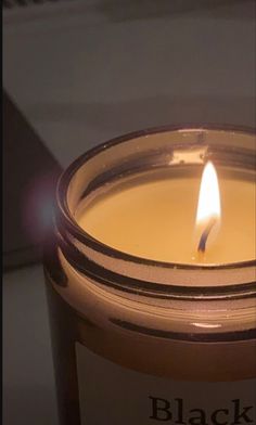 a lit candle sitting on top of a table