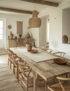 a dining room table with chairs and a bowl on it