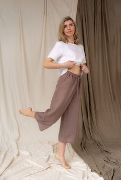 Relaxed style with fair made linen trousers. MyLinenSould pants are elastic high-waisted linen pants, that you can wear anywhere anytime. Natural linen pants with pockets is so comfortable. Loose fit silhouette delivers resort-inspired look. Handmade linen pants is finished with side pockets and tie detail at the waist line. Elasticated waist band is super soft so you won't feel any pressure or discomfort.  Model in picture is 5.6ft (172cm) tall. She is wearing size S Please check our SIZE CHART Casual Wide-leg Linen Capris, Wide Leg Relaxed Fit Summer Capris, Wide Leg Relaxed Fit Capris For Summer, Summer Wide Leg Relaxed Fit Capris, Casual Wide Leg Linen Capris, Summer Linen Harem Pants Straight Cut, Summer Linen Harem Pants, Relaxed Fit Wide-leg Summer Capris, Non-stretch Linen Beach Bottoms