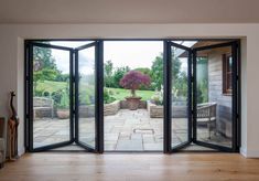 an open patio door leading to a garden