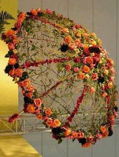 an umbrella made out of flowers and vines