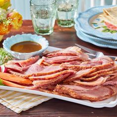 ham and carrots on a platter with dipping sauce