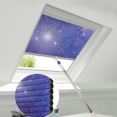 a room with a window that has a blue roller shade on the top and bottom