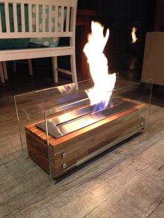 a fire pit sitting on top of a wooden floor