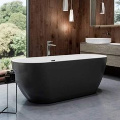 a bathroom with a large bathtub next to a window