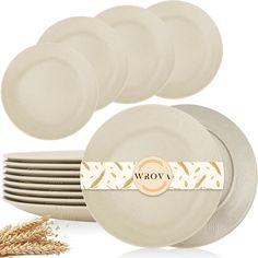 a stack of white plates with the word wow on it next to some wheat stalks