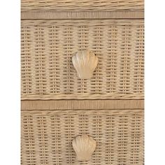 two seashells are placed on the wicker drawers