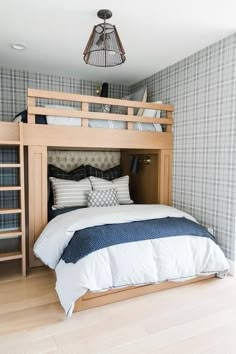 a bedroom with a bunk bed that is built into the wall and has two ladders