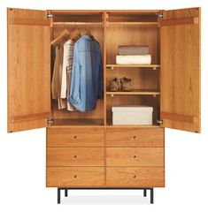 an open wooden wardrobe with clothes hanging on it