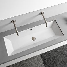 a bathroom sink with two faucets on the side and a mirror above it