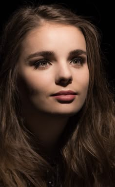 a woman with long hair and brown eyes