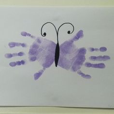 a drawing of a butterfly made out of handprints on a piece of paper