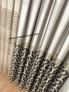 the curtains are lined up with black and white designs