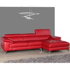 a red leather sectional sofa sitting on top of a rug