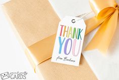 a thank you gift tag attached to a brown box with a yellow bow on it