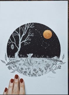 a person holding up a drawing in front of a tree and the moon at night