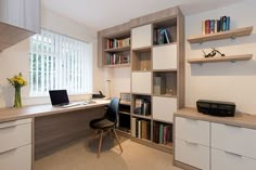 a home office with shelves, desk and computer