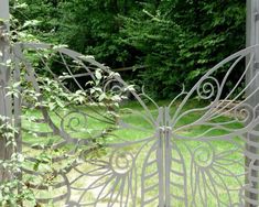 an iron gate in the shape of a butterfly