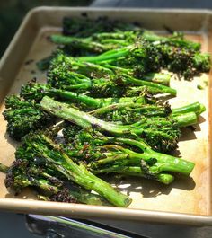 some broccoli is sitting on a wooden tray