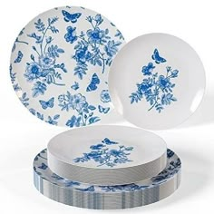 blue and white plates stacked on top of each other with butterflies in the center,