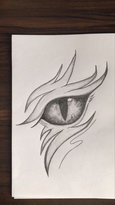 a drawing of an eye with flames coming out of the iris's eyes, on paper