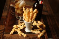 a cup filled with cheetos sitting on top of a wooden table