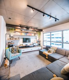 a living room filled with furniture and a flat screen tv mounted to the side of a wall