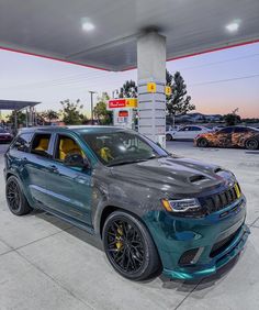 a blue jeep parked in front of a gas station