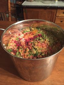 a large metal pot filled with food on top of a wooden table