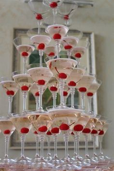 there are many wine glasses that are stacked on top of each other in the shape of a pyramid