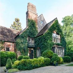 a large brick house covered in ivy