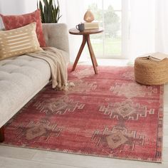 a living room area with a couch, coffee table and rug