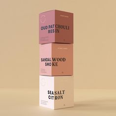 three boxes stacked on top of each other with the words sandal wood smo ke