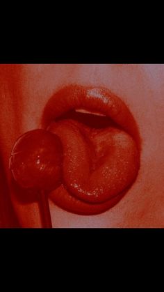 a woman's lips are shown with the tongue sticking out