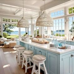 a kitchen filled with lots of counter top space next to an open floor plan and large windows