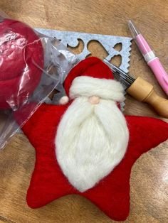 a red and white christmas ornament with a santa clause on it