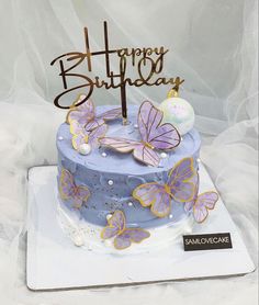 a birthday cake with purple butterflies on it