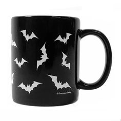 a black coffee mug with white bats on it