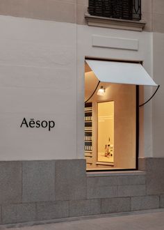 a store front with the name aesop on it's side and an open door