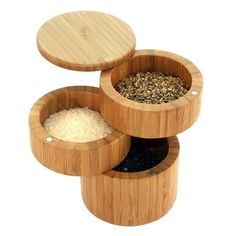 three wooden containers filled with different types of spices and seasoning, one is empty