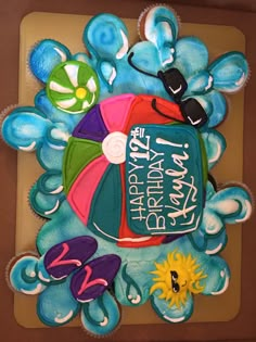 a birthday cake decorated with an umbrella and flip flops